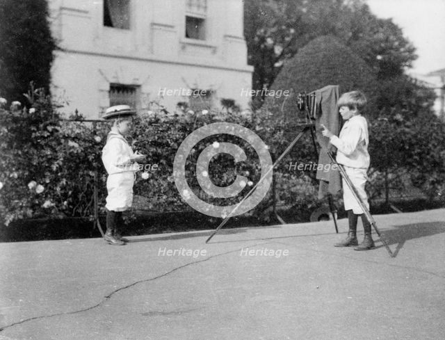 Archie Roosevelt photographing Quentin Roosevelt outdoors, 1902. Creator: Frances Benjamin Johnston.