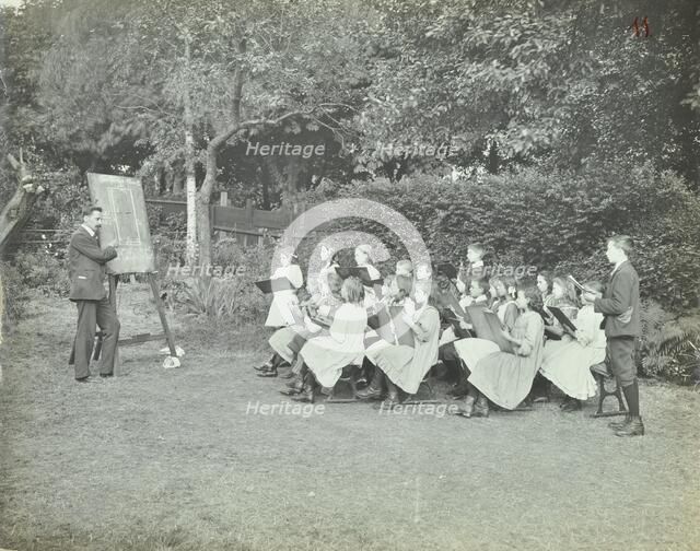 Arithmetic lesson in the garden, Birley House Open Air School, London, 1908. Artist: Unknown.