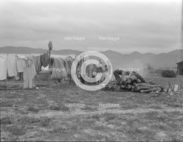 Arkansas family washing dishes, seven months in California, 1936. Creator: Dorothea Lange.