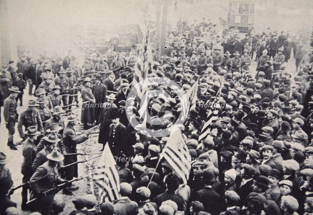 Armed troops confronting protesters during an industrial dispute, USA, 1912.  Creator: Unknown.