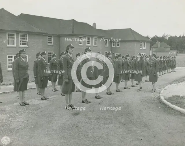 Army nurses standing at attention in front of their barracks and being inspected by..., 1939 - 1945. Creator: Unknown.