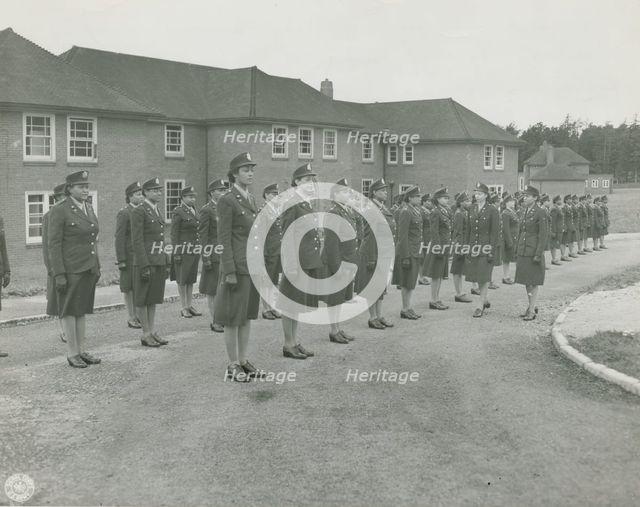 Army nurses standing at attention in front of their barracks and being inspected by..., 1939 - 1945. Creator: Unknown.