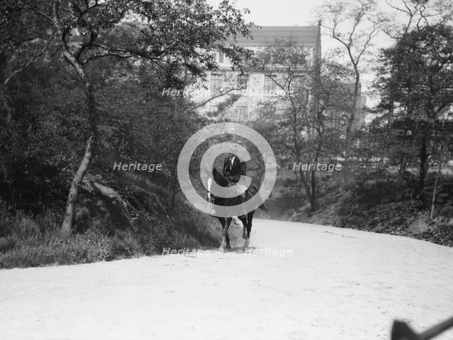 Arnold Genthe riding Chesty, between 1911 and 1936. Creator: Arnold Genthe.