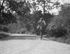 Arnold Genthe riding Chesty, between 1911 and 1936. Creator: Arnold Genthe