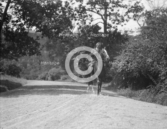 Arnold Genthe riding Chesty, between 1911 and 1936. Creator: Arnold Genthe.