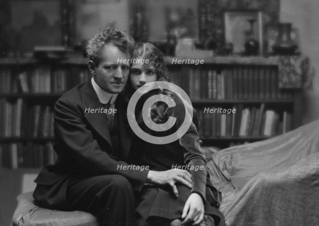 Arnold Genthe seated next to a woman friend in his studio in San Francisco, between 1896 and 1911. Creator: Arnold Genthe.
