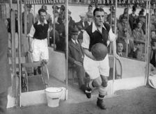 Arsenal FC captain Eddie Hapgood runs onto the pitch at Highbury, London, 1930s. Artist: Barratt's Photo Press Ltd