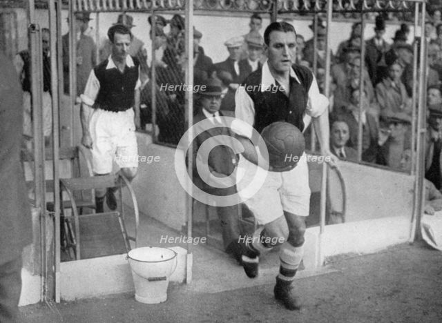Arsenal FC captain Eddie Hapgood runs onto the pitch at Highbury, London, 1930s. Artist: Barratt's Photo Press Ltd