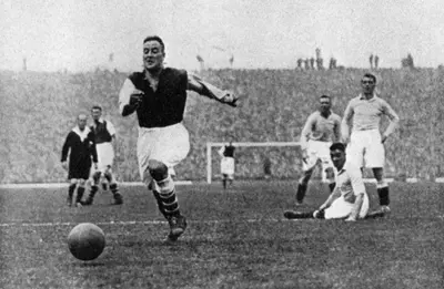 Arsenal footballer Alex James passes three Manchester City players, c1929-c1937. Artist: Graphic Photo Union