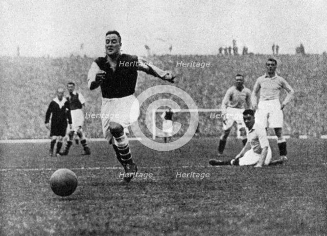 Arsenal footballer Alex James passes three Manchester City players, c1929-c1937. Artist: Graphic Photo Union