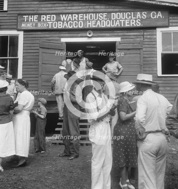 As the auctioneer knocks down the last bid on each basket of tobacco..., Douglas, Georgia, 1938. Creator: Dorothea Lange.