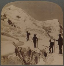 Ascent of Mt. Blanc - crossing Bossons Glacier - Grands Mulets in distance, Alps 1901. Creator: Underwood & Underwood
