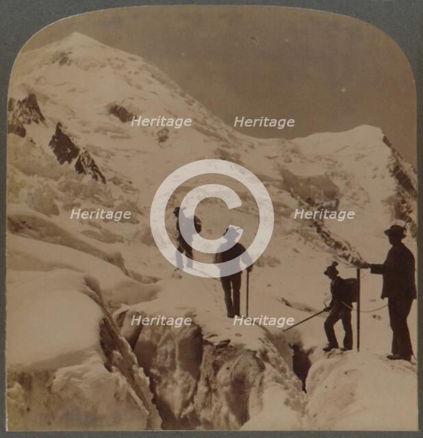 'Ascent of Mt. Blanc - crossing Bossons Glacier - Grands Mulets in distance, Alps', 1901. Creator: Underwood & Underwood.
