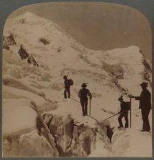 Ascent of Mt. Blanc - crossing Bossons Glacier - Grands Mulets in distance, Alps 1901. Creator: Underwood & Underwood