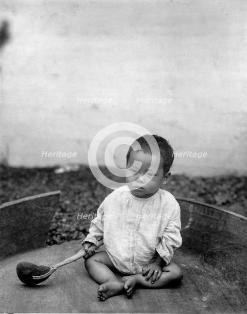 Asian(?) baby seated holding spoon or ladle, World's Columbian Exposition, Chicago, Ill., 1891 or 92 Creator: Frances Benjamin Johnston.