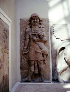 Assyrian sculpture of Gilgamesh holding a lion, Khorsabad, c8th century BC