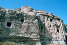 Assyrian rock reliefs pitted by Chr hermit caves, Bavian, Iraq, 1977