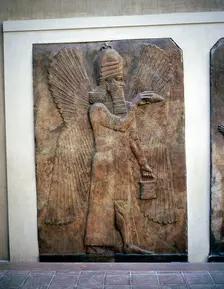 Assyrian relief of a winged genie with a bucket & a cedar cone, Khorsabad, 8th century BC