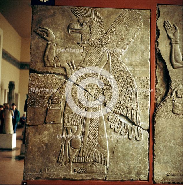Assyrian relief of Winged genie carrying a cedar-cone. Artist: Unknown