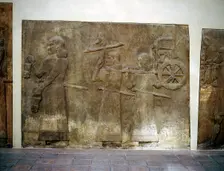 Assyrian relief showing servants carrying the King's chariot, Khorsabad, c8th century BC