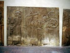 Assyrian relief showing servants carrying the King's chariot, Khorsabad, c8th century BC