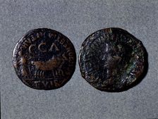 At left a coin with the legend Scipione er Montano II vir CCA at right the front with the word…