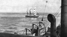 At sea; During boarding, a patrol cruiser turns on the visiting vessel which it encircles..., 1917. Creator: Unknown