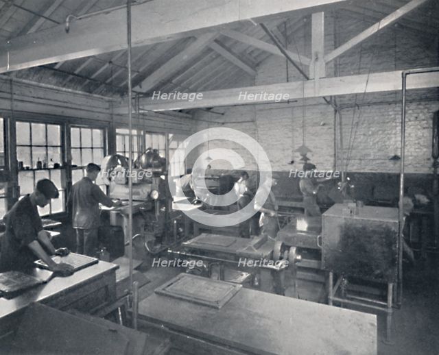 'At Work in the Foundry. Making Wax Moulds of the Pages', 1917. Artist: Unknown.