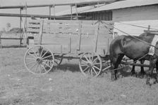 At the cotton gin, Cotton gin and wagons, Hale County, Alabama, 1936. Creator: Walker Evans