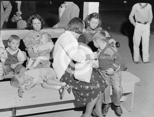 At the end of the Halloween party at Shafter migrant camp, California, 1938. Creator: Dorothea Lange.