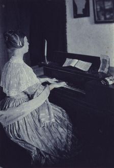 At the spinet, c1900. Creator: Frances S. Allen