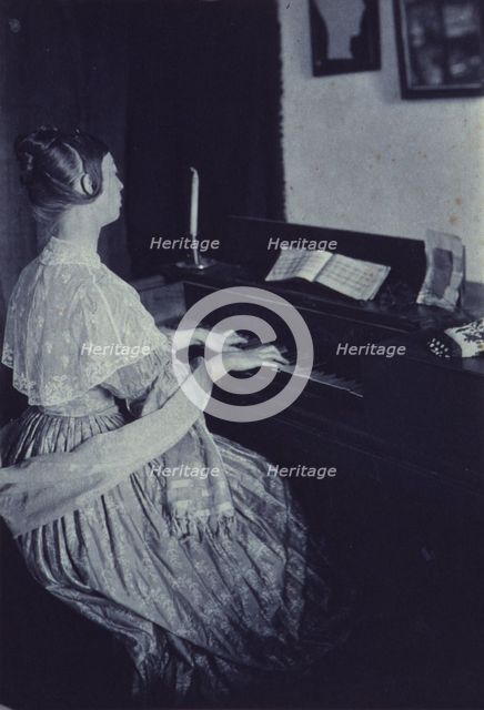 At the spinet, c1900. Creator: Frances S. Allen.