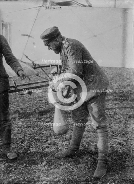 Attaching bomb to German Aeroplane, 16 Jan 1915. Creator: Bain News Service.
