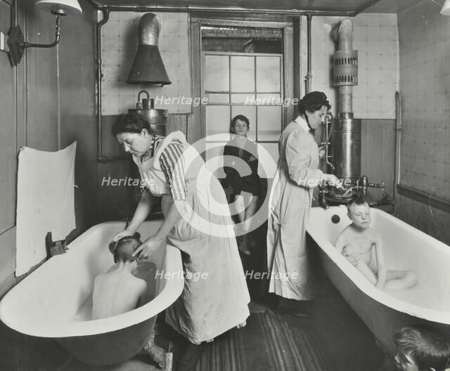 Attendants bathing boys at the Central Street Cleansing Station, London, 1914. Artist: Unknown.