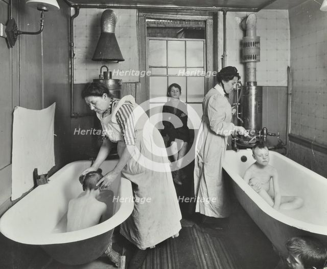 Attendants bathing boys at the Central Street Cleansing Station, London, 1914. Artist: Unknown.