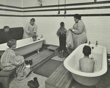 Attendants bathing boys at the Sun Court Cleansing Station, London, 1914