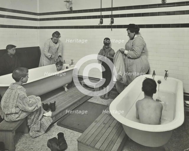 Attendants bathing boys at the Sun Court Cleansing Station, London, 1914. Artist: Unknown.