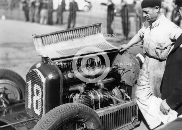 Attilio Marinoni, chief mechanic of Scuderia Ferrari, with an Alfa Romeo, 1934. Artist: Unknown