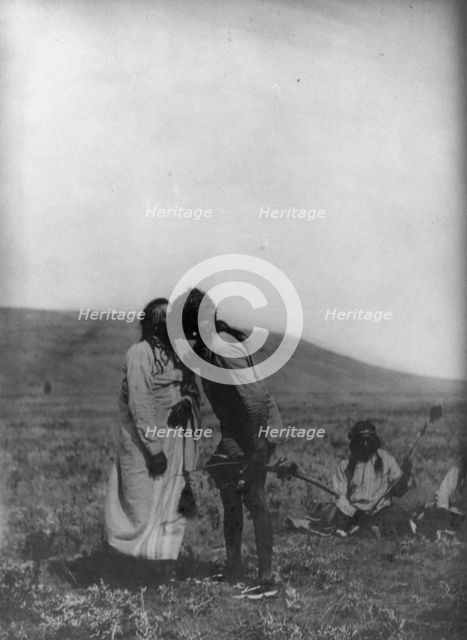 Atsina crazy dance-[A dancer kisses the grandfather], c1908. Creator: Edward Sheriff Curtis.