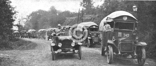 'Au Volant; convoi d'autos-camions menes par des conducteurs indo-chinois, sous..., 1918. Creator: Unknown.
