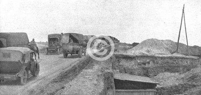'Au Volant; Une route du front: arrivee des convois dans la zone avancee', 1918. Creator: Unknown.