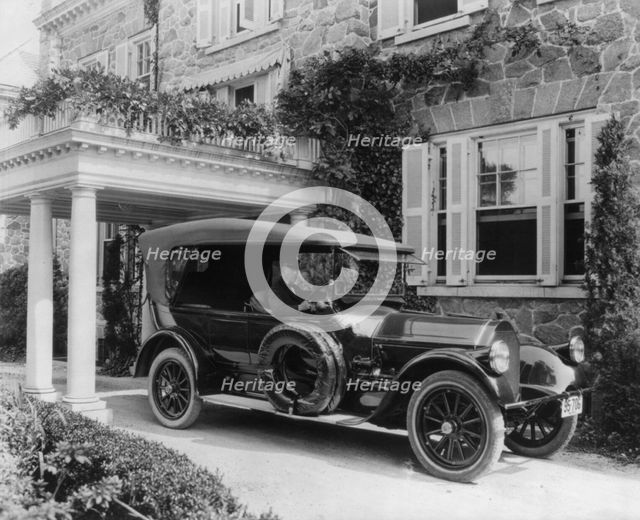 Automobile owned by Mrs. Charles W. Richardson in driveway with driver at the...Washington DC, c1919 Creator: Frances Benjamin Johnston.