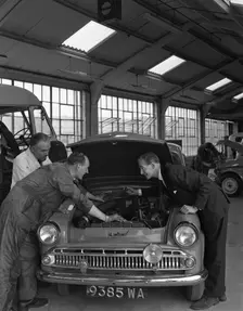 Automotive supplies representative with a 1960 Hillman Husky at a Sheffield Garage, 1963. Creator: Michael Walters