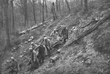 Aux Eparges; Le transport des blesses sur les pentes boisees des Eparges 1915 (1924). Creator: Unknown