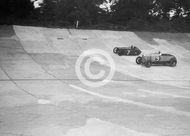 Austin 747 cc works racer and another car on the Members Banking at Brooklands. Artist: Bill Brunell.