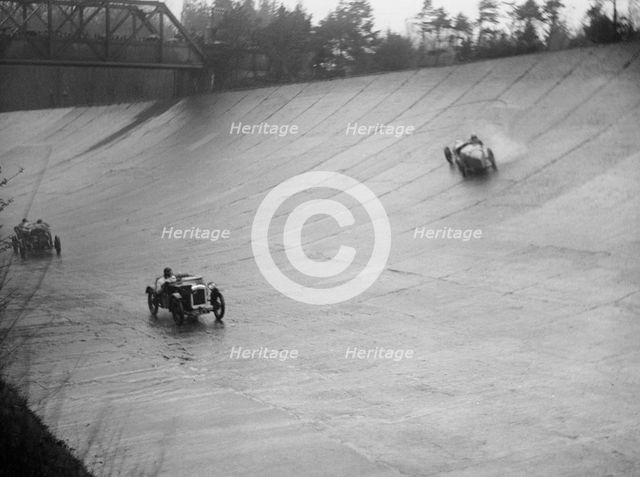 Austin 7 and the spinning Riley of HL Roberts, BARC Mountain Race, Brooklands, Surrey, 1931 Artist: Bill Brunell.