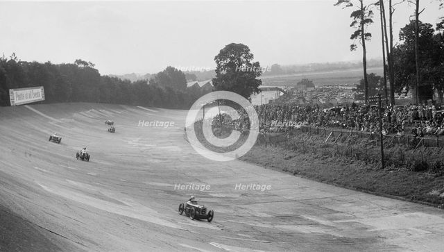 Austin 7 of Charles Goodacre and MG C of the Earl of March, BRDC 500 Mile Race, Brooklands, 1931. Artist: Bill Brunell.