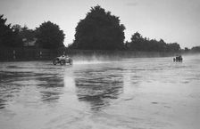 Austin 7 leading a MG in the wet at the LCC Relay GP, Brooklands, 25 July 1931. Artist: Bill Brunell