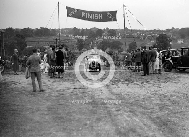 Austin Swallow of Mrs A Stanley at the finish of the Middlesex County AC Hill Climb, c1930. Artist: Bill Brunell.