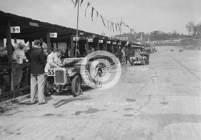 Austin Ulster and MG C type in the pits at the JCC Double Twelve race, Brooklands, 8/9 May 1931. Artist: Bill Brunell.
